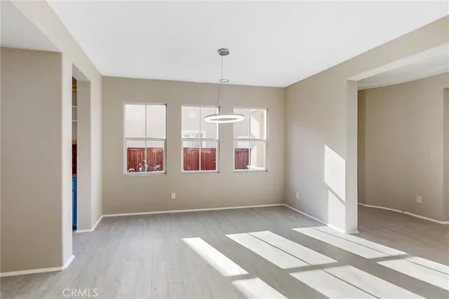 an empty room with windows and entrance