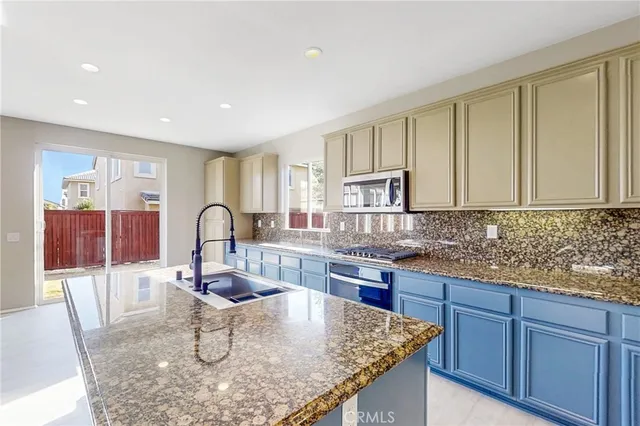 a kitchen with granite countertop white cabinets and granite counter tops
