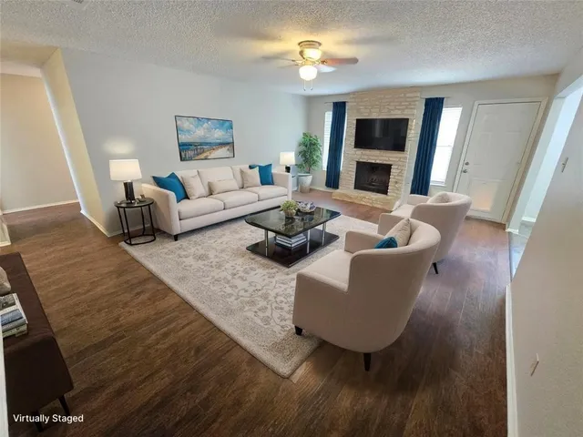 a living room with furniture and a fireplace