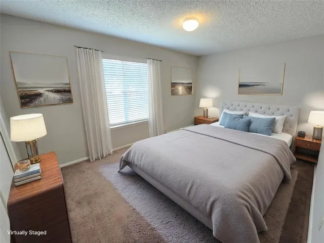 a bedroom with a bed and a lamp