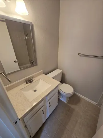 a bathroom with a sink a toilet and mirror