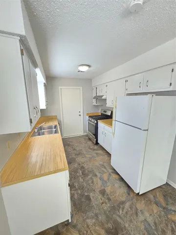 a kitchen with stainless steel appliances a refrigerator and a stove