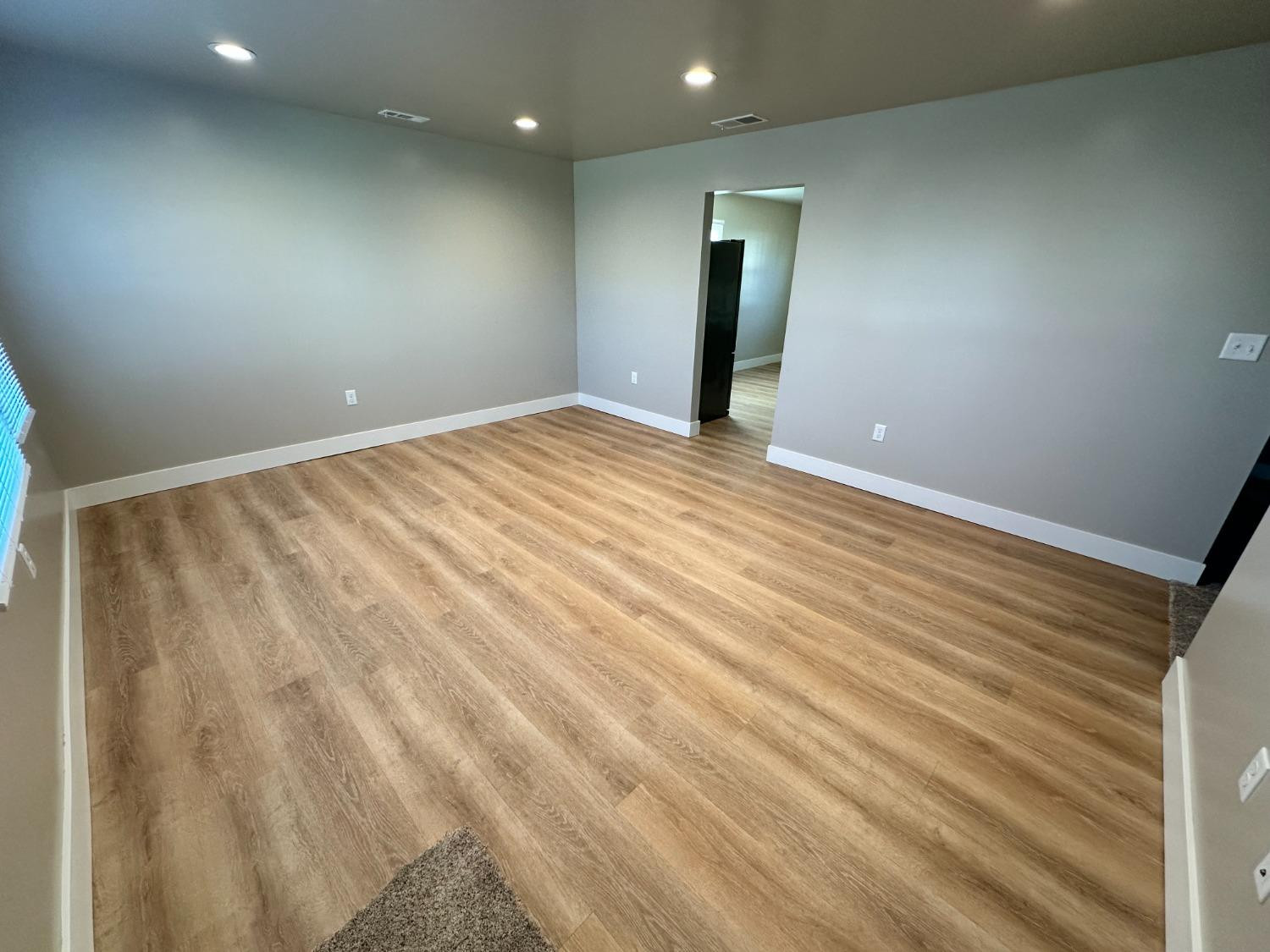 734-1 Imperial Road Valparaiso, IN 46385 - Photo 5 of 9 an empty room with wooden floor and windows