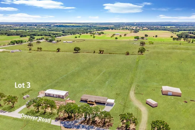 an aerial view of a houses with a swimming pool