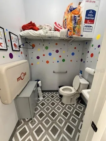a bathroom with a sink toilet and shower curtain