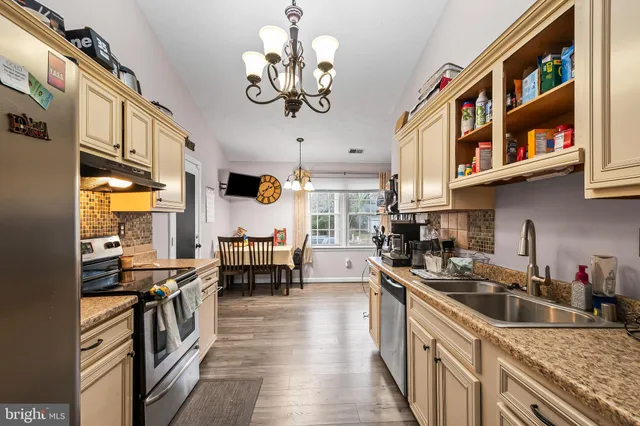 a kitchen with stainless steel appliances granite countertop a sink and stove