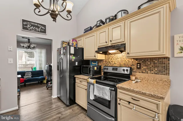 a kitchen with stainless steel appliances granite countertop a stove and cabinets