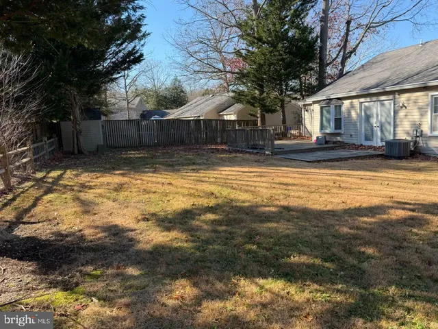 a swimming pool with outdoor seating and yard
