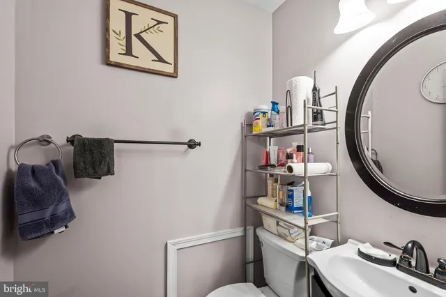 a bathroom with a sink mirror and toilet
