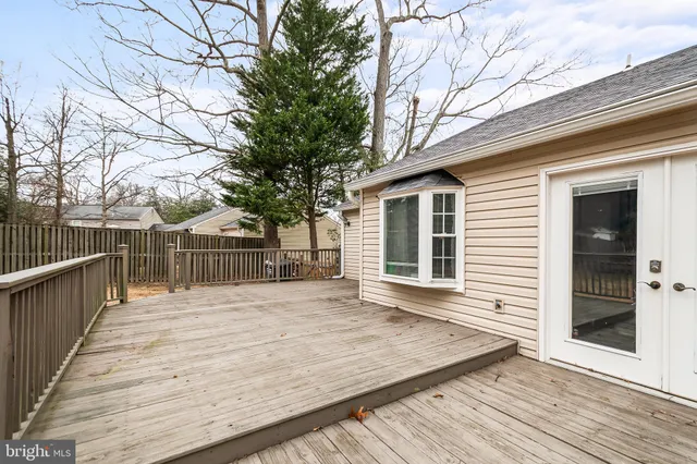 a view of backyard with deck and wooden floor