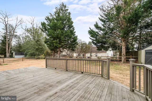 a view of a patio with wooden floor and fence