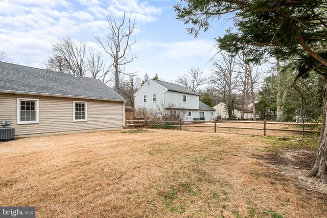 a view of a yard with a house and large tree