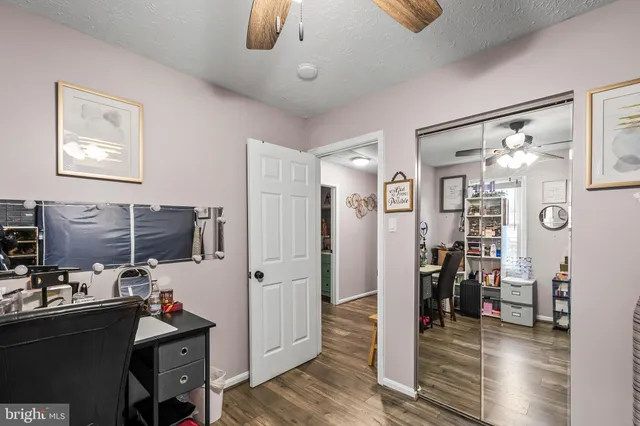 a view of a livingroom with workspace and a window
