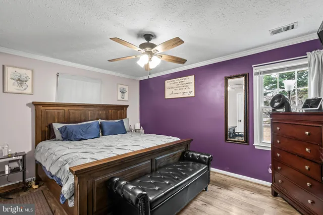 a bed room with a bed and a dresser