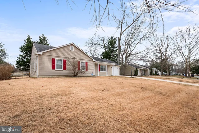 a front view of house with yard and trees around