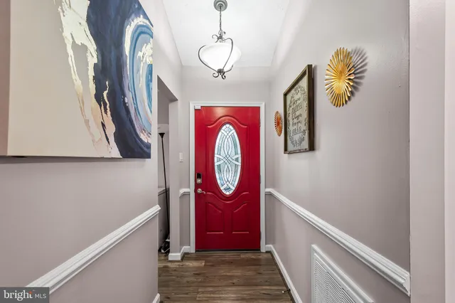 a view of entryway with hallway and wooden floor