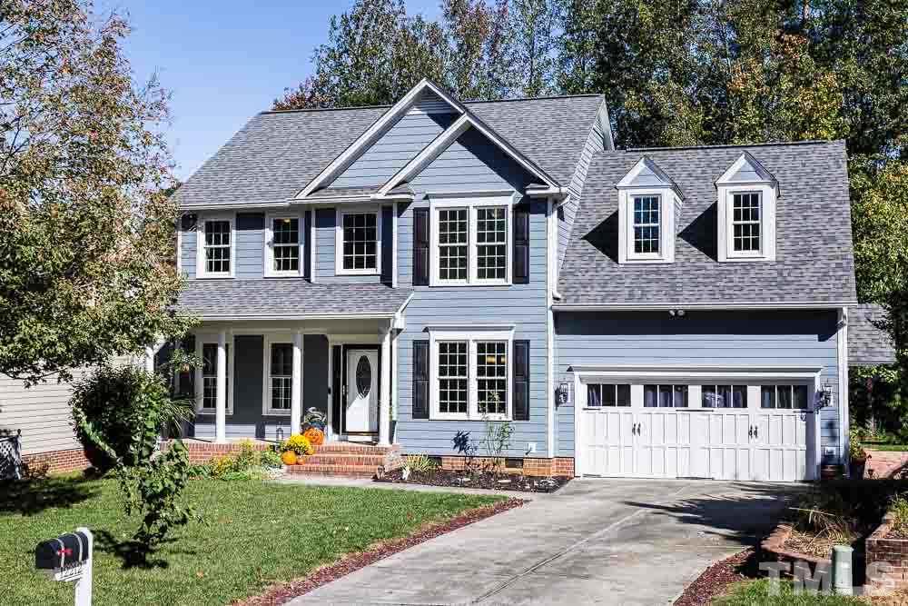 12212 Amoretto Way Raleigh, NC 27613 - Photo 1 of 30 a front view of a house with garden and porch