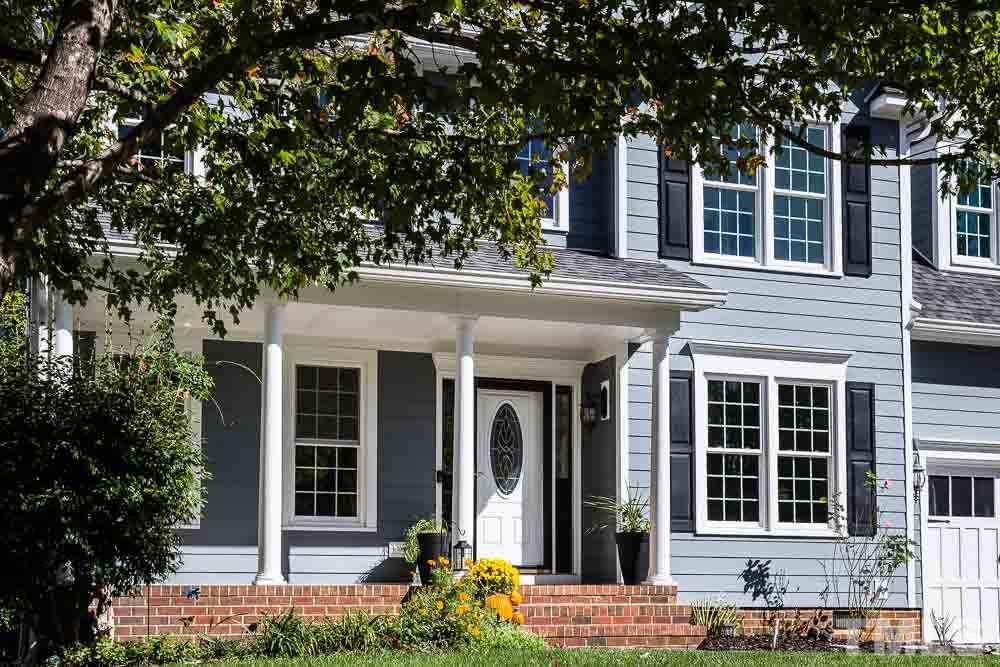 12212 Amoretto Way Raleigh, NC 27613 - Photo 2 of 30 front view of a brick house with a large window and potted plants