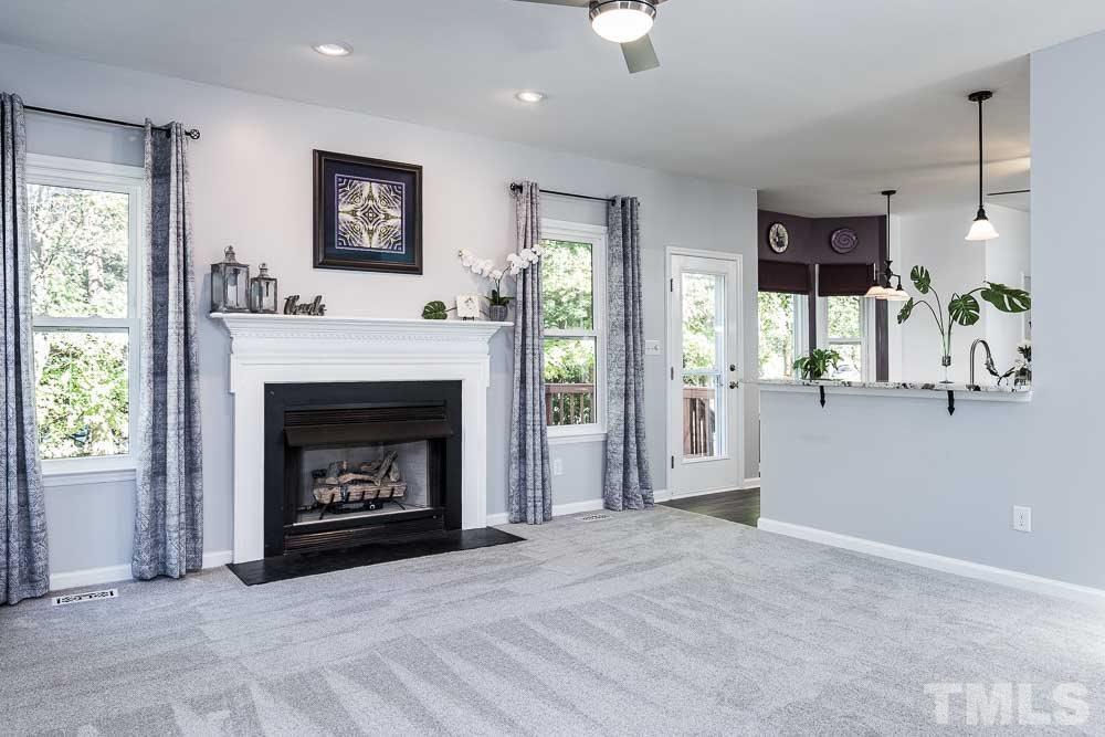 12212 Amoretto Way Raleigh, NC 27613 - Photo 11 of 30 a living room with furniture and a fireplace