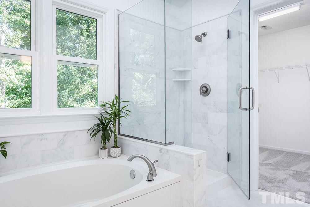 12212 Amoretto Way Raleigh, NC 27613 - Photo 17 of 30 a white bath tub with a shower