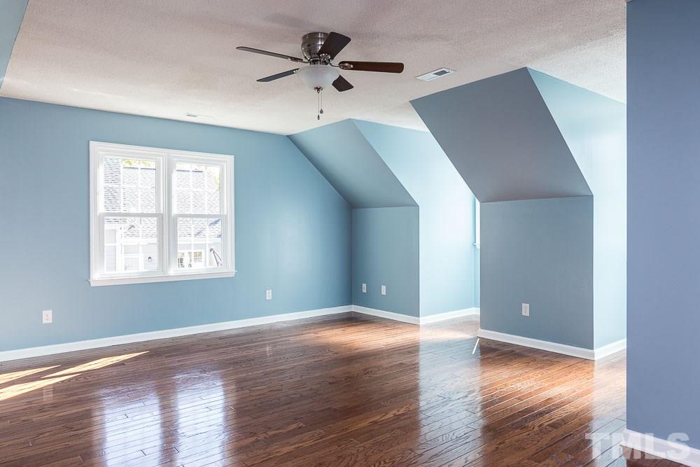 12212 Amoretto Way Raleigh, NC 27613 - Photo 23 of 30 an empty room with wooden floor and windows