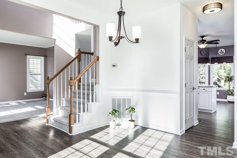 12212 Amoretto Way Raleigh, NC 27613 - Photo 7 of 30 a view of an entryway with wooden floor