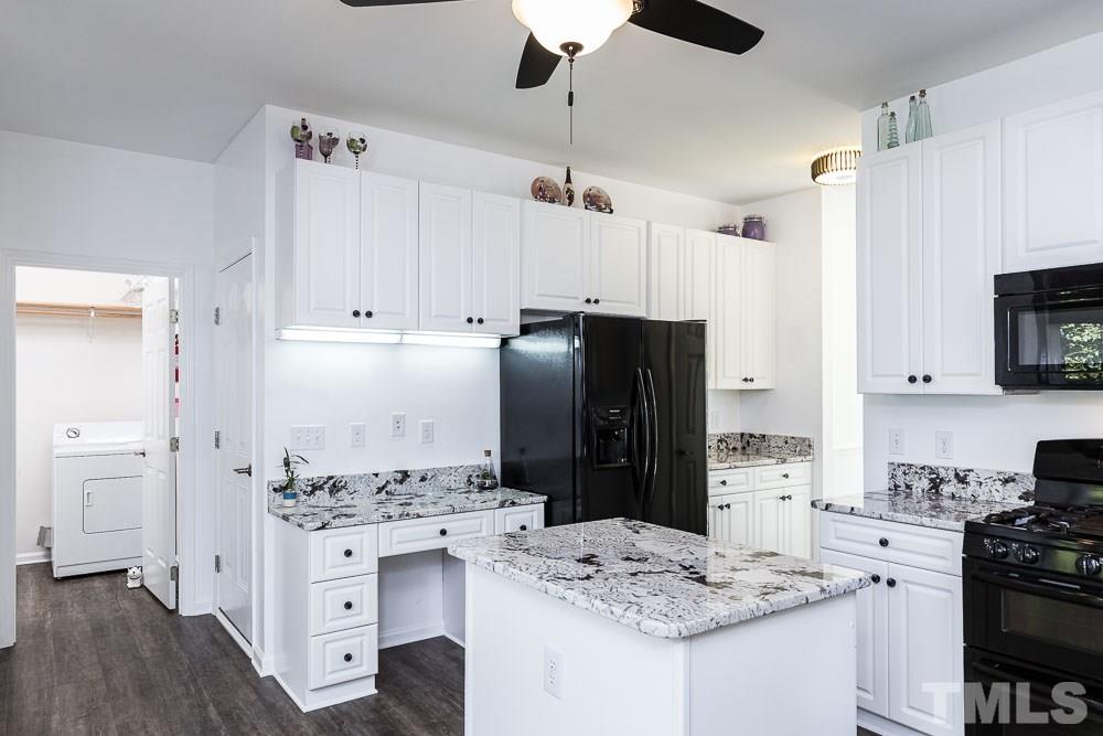 12212 Amoretto Way Raleigh, NC 27613 - Photo 10 of 30 a kitchen with granite countertop a refrigerator stove and sink