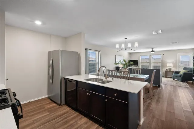 a kitchen with a sink appliances and cabinets