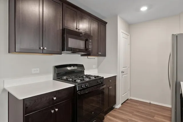 a kitchen with granite countertop a stove and a refrigerator