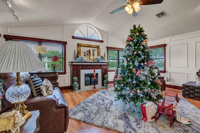 a living room with furniture a flat screen tv and a fireplace
