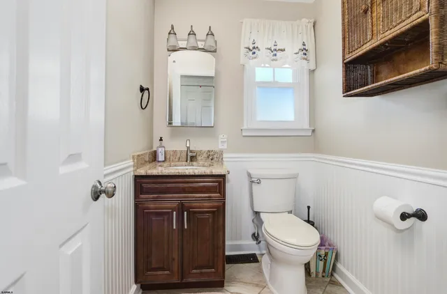 a bathroom with a toilet a sink and mirror