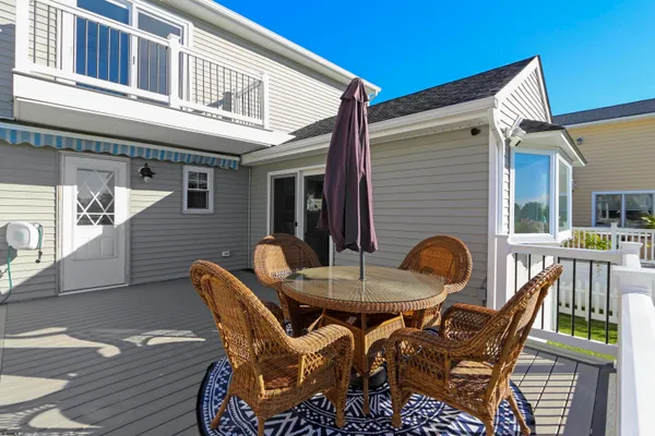 a view of a patio with table and chairs and wooden floor