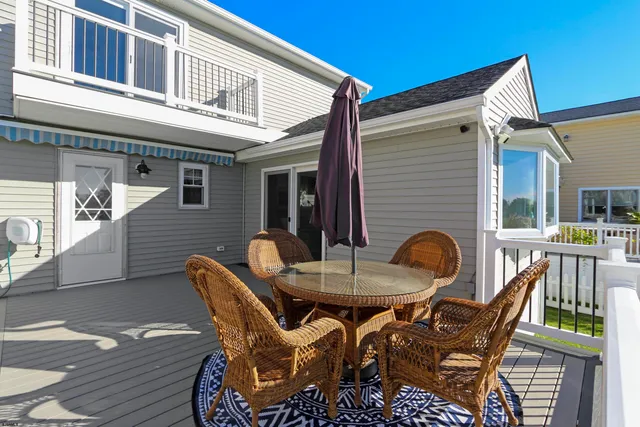 a view of a patio with table and chairs and wooden floor