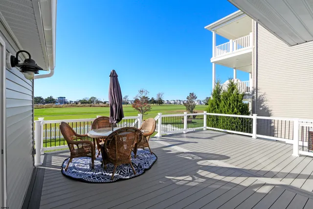 a view of a roof deck with chair and table