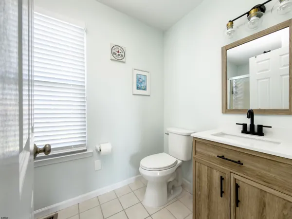 a bathroom with a toilet a sink and a mirror