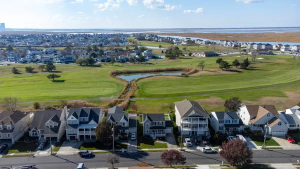 an aerial view of a building with outdoor space seating area and swimming pool