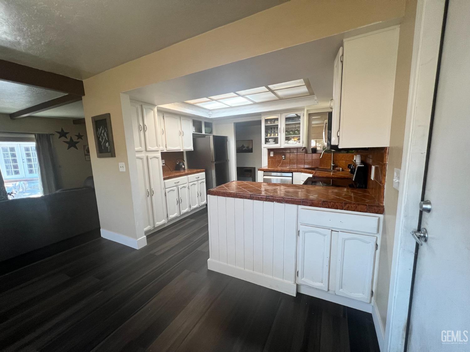 Undisclosed Address Tehachapi, CA 93561 - Photo 11 of 22 a kitchen with granite countertop a stove and cabinets