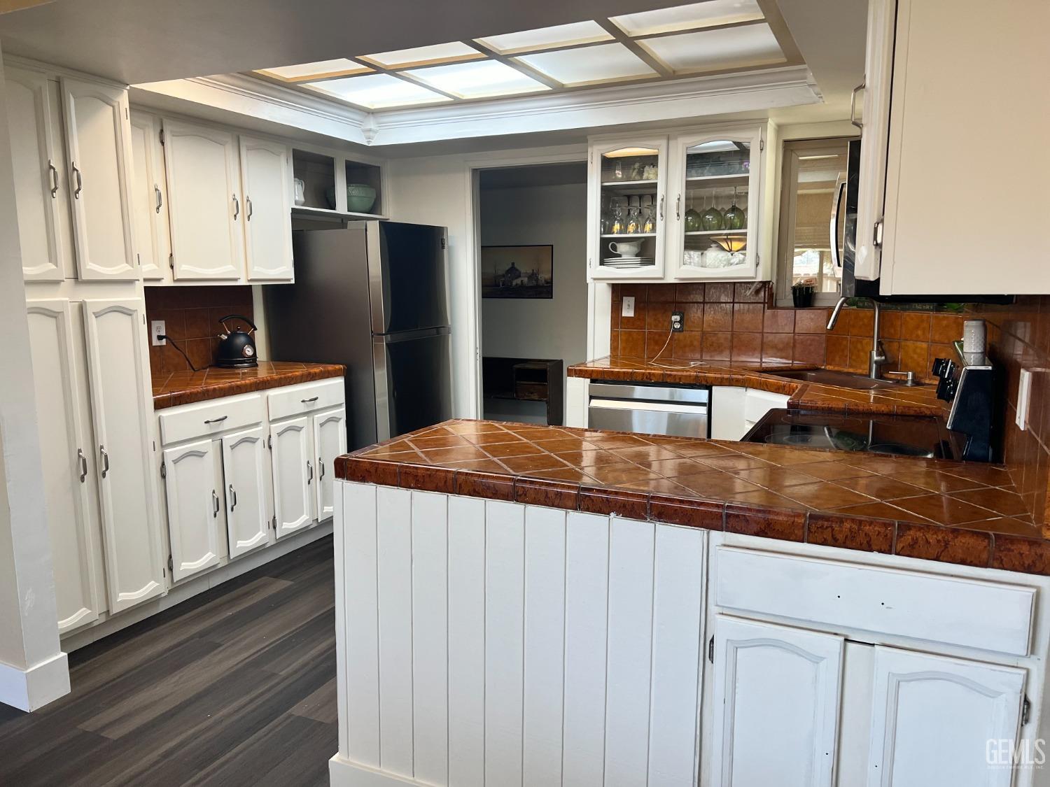 Undisclosed Address Tehachapi, CA 93561 - Photo 21 of 22 a kitchen with stainless steel appliances granite countertop a sink and dishwasher a refrigerator with wooden cabinets