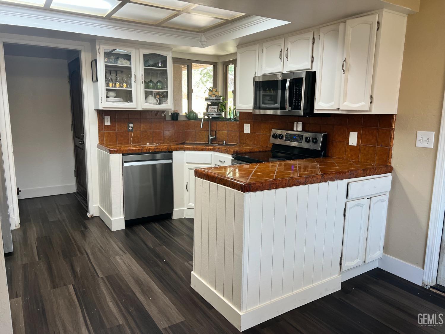 Undisclosed Address Tehachapi, CA 93561 - Photo 9 of 22 a kitchen with granite countertop a stove and a sink