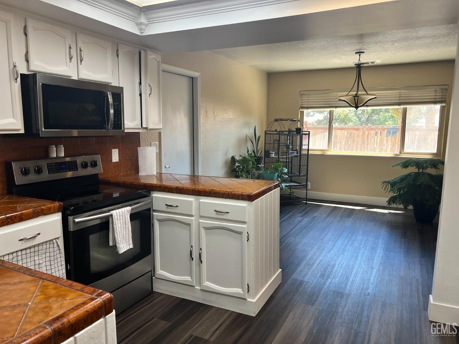 Undisclosed Address Tehachapi, CA 93561 - Photo 10 of 22 a kitchen with a stove a sink and a flat screen tv