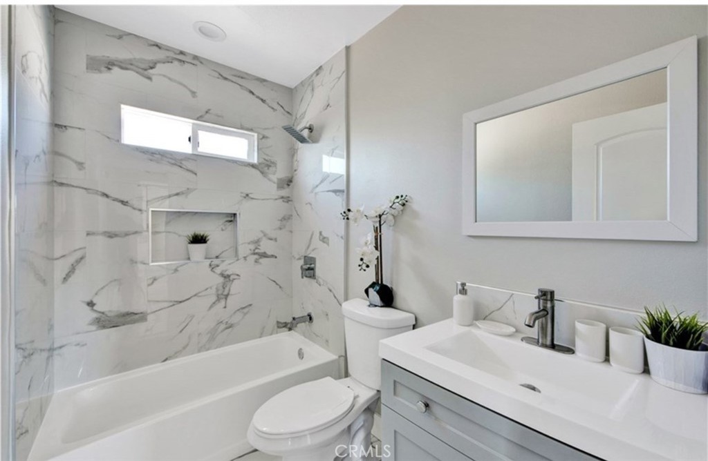 907 West Arbutus Street Compton, CA 90220 - Photo 7 of 8 a bathroom with a sink a toilet and shower