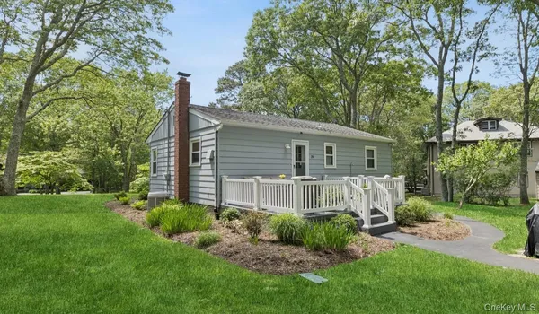 a backyard of a house with potted plants and large tree
