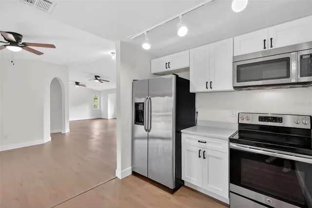 a kitchen with stainless steel appliances a stove a microwave and a refrigerator