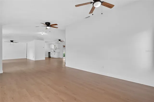 a view of empty room with a ceiling fan