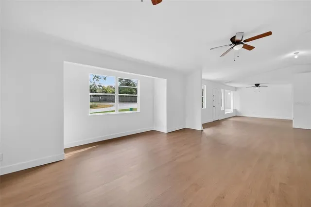 an empty room with windows and closet