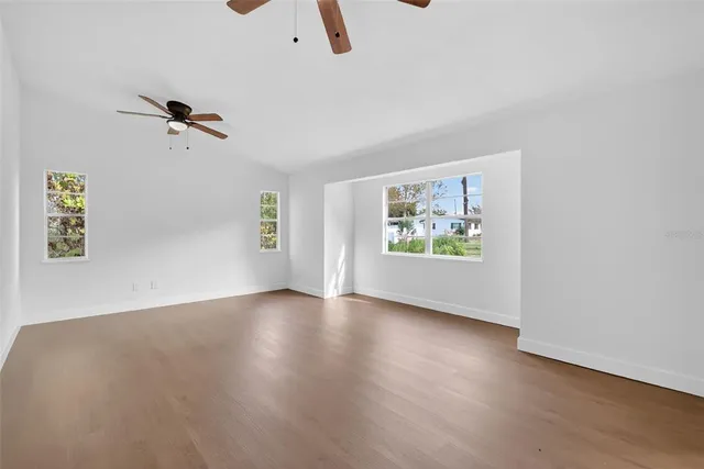 wooden floor in an empty room with a window
