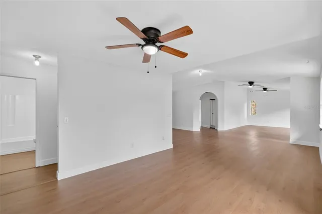a view of a livingroom with a ceiling fan and window