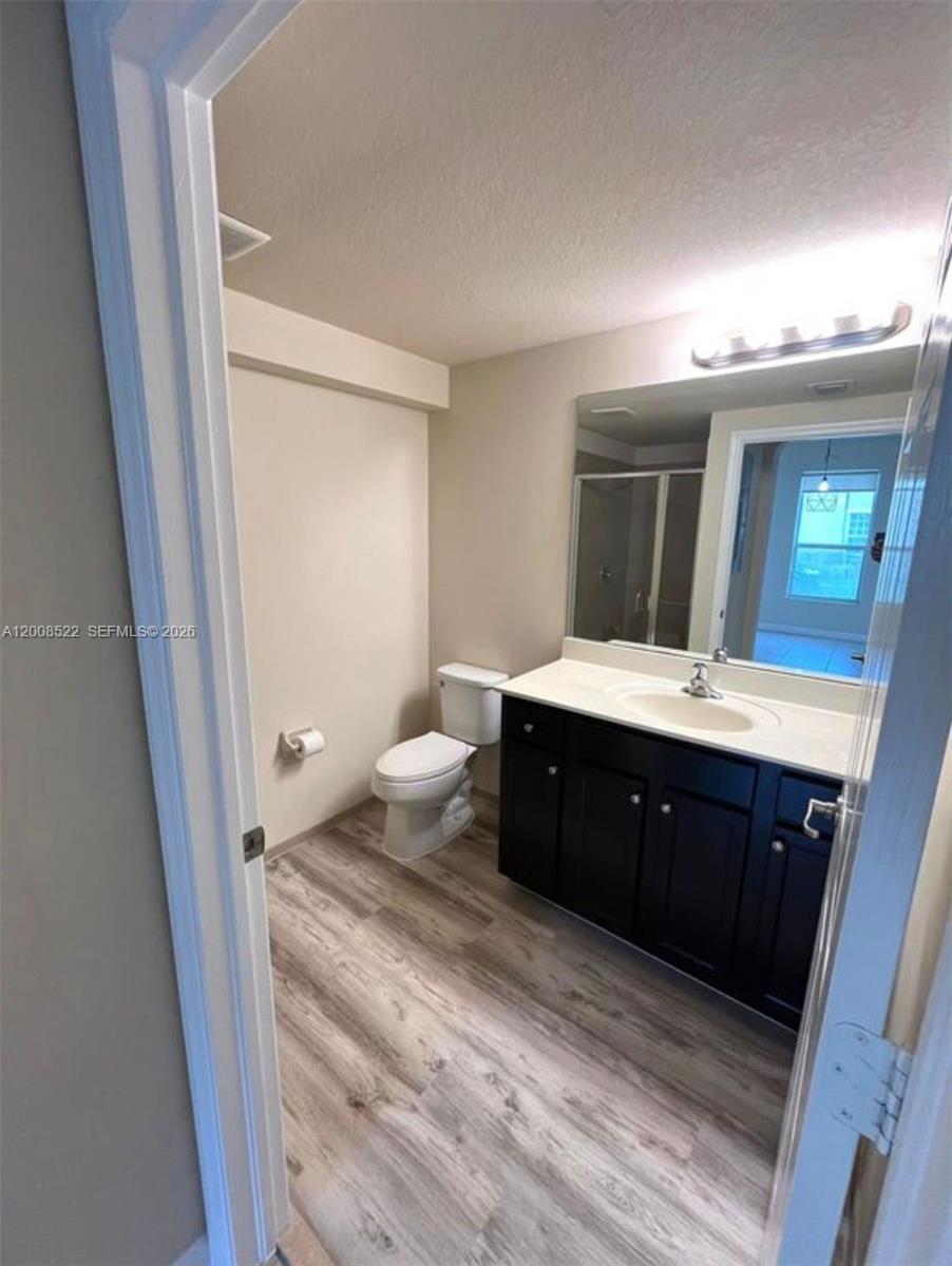 9401 Southwest 172nd Avenue, Unit 9401 Miami, FL 33196 - Photo 11 of 34 a bathroom with a double vanity sink and mirror