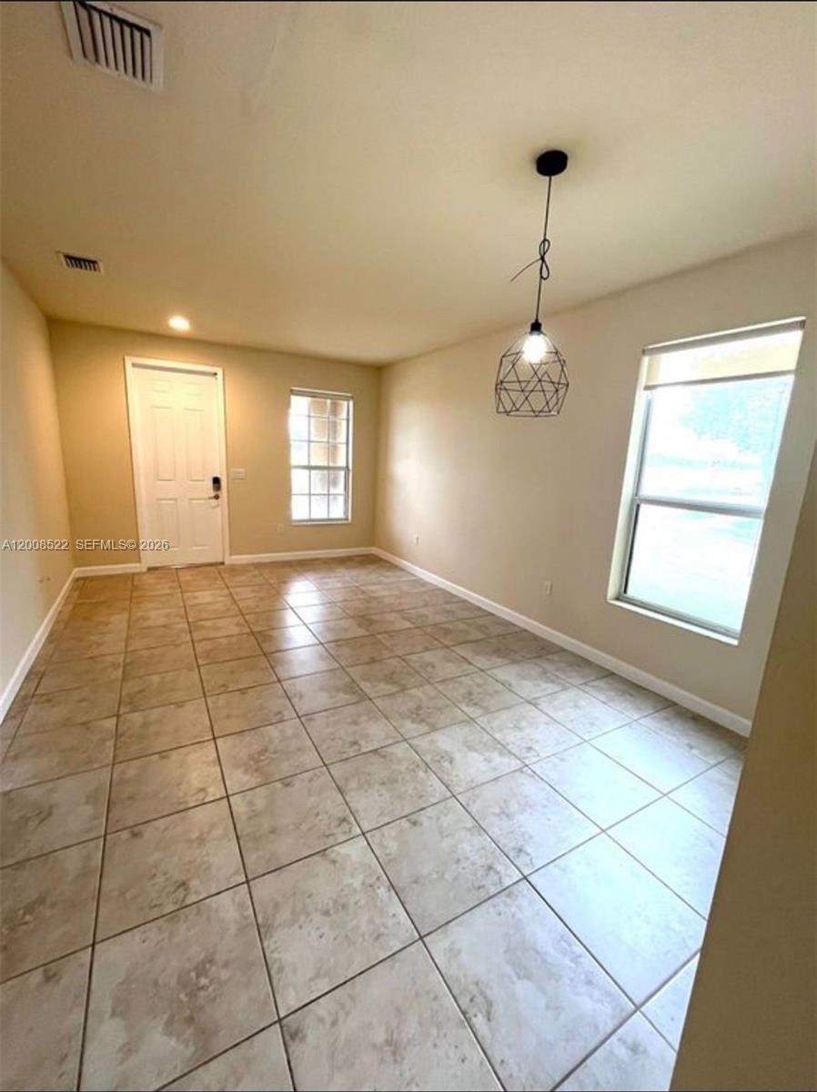9401 Southwest 172nd Avenue, Unit 9401 Miami, FL 33196 - Photo 12 of 34 a view of an empty room with a window