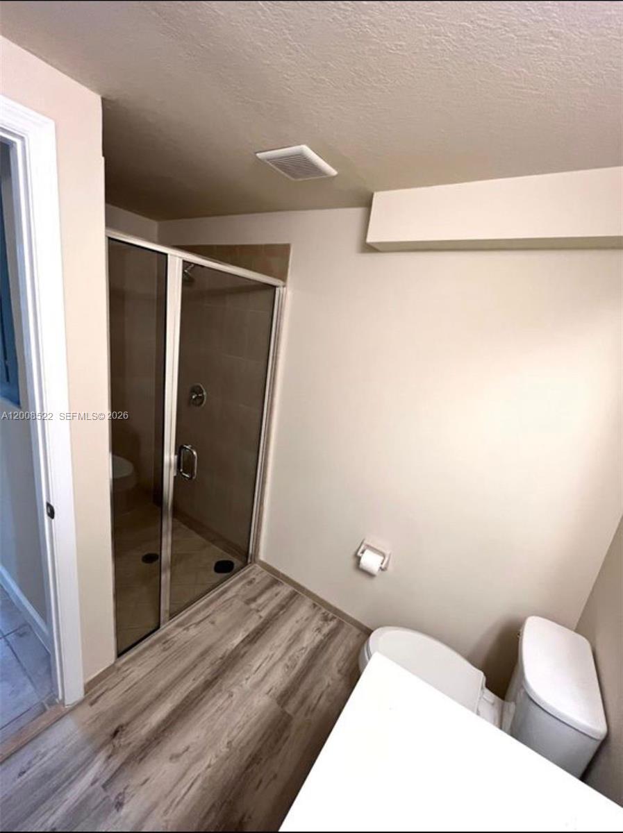 9401 Southwest 172nd Avenue, Unit 9401 Miami, FL 33196 - Photo 13 of 34 a bathroom with a toilet and a shower